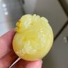 The natural raw mineral white flower cleverly carved and colorful honey wax money bag pendant is approximately 36.6x31.9x29.4mm in size0811790133
